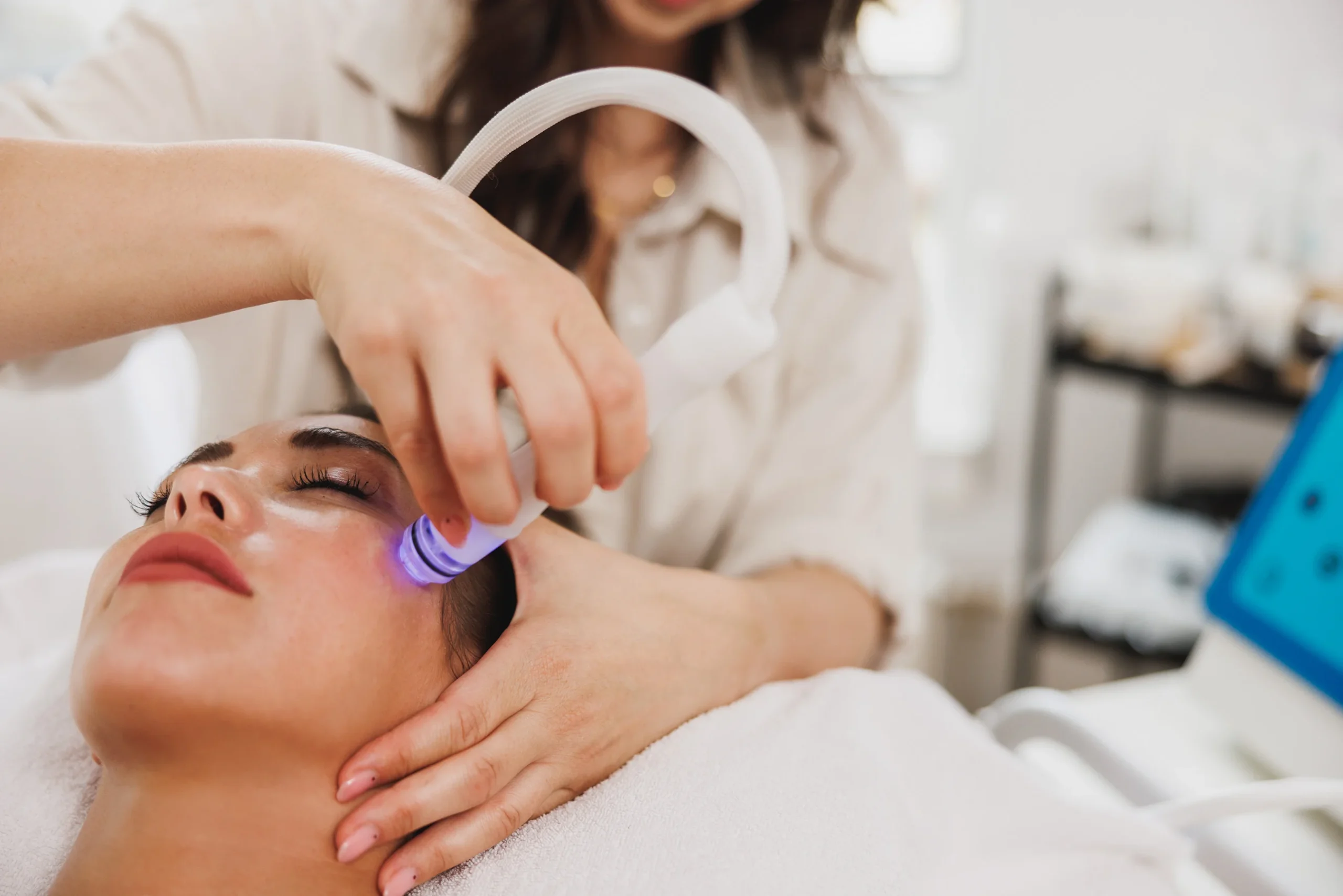 Female patient receiving sun damage treatment on her face.