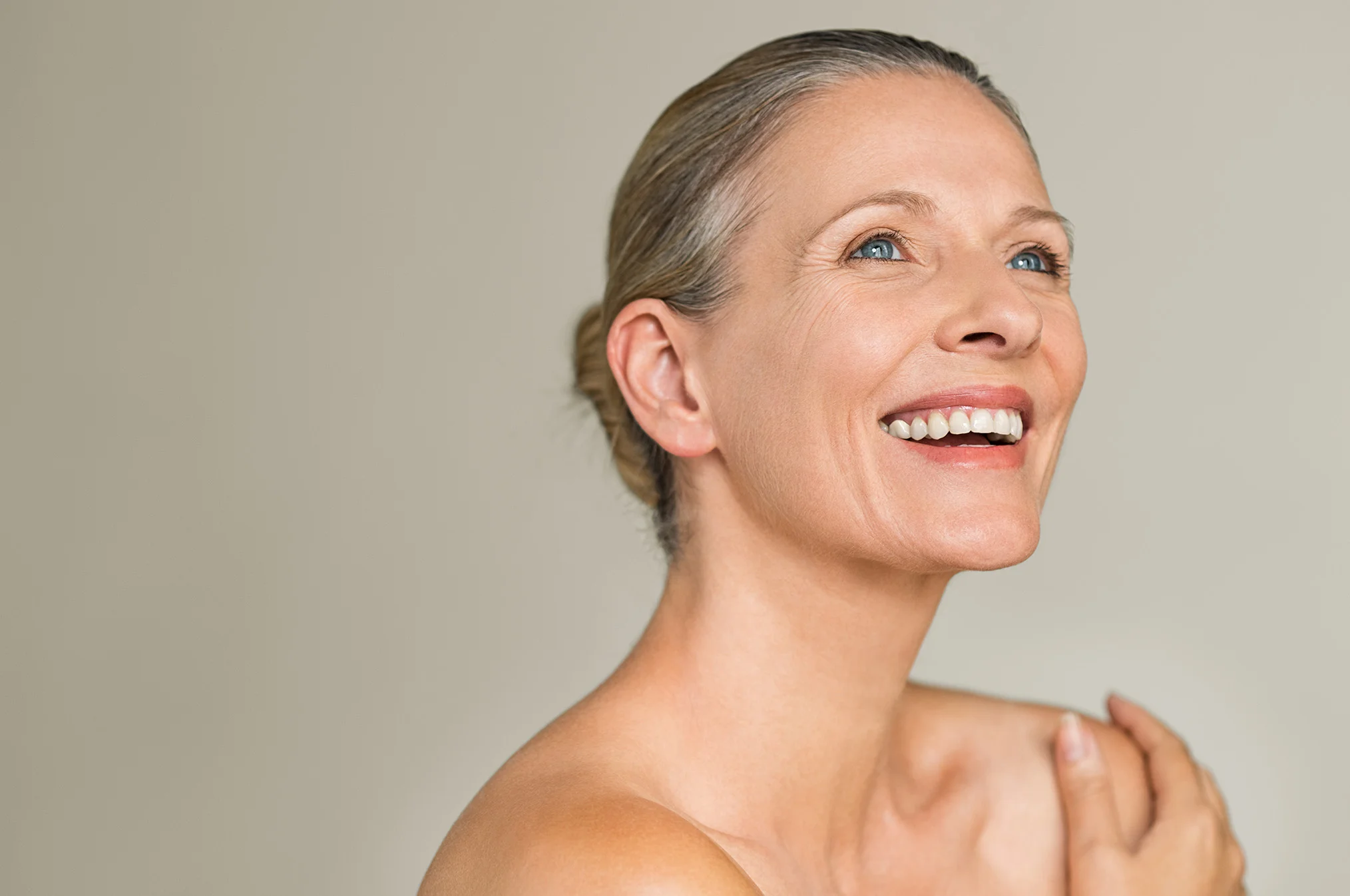 Smiling, healthy woman representing comfort and wellness associated with vaginal dryness treatment.